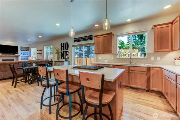 a kitchen with a table chairs sink and cabinets
