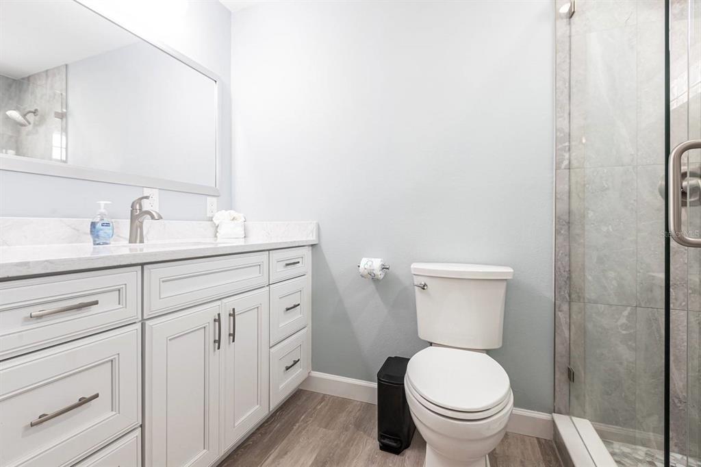 6020 Midnight Pass Road, Unit 64 Sarasota, FL 34242 - Photo 12 of 14 a bathroom with a toilet sink and mirror