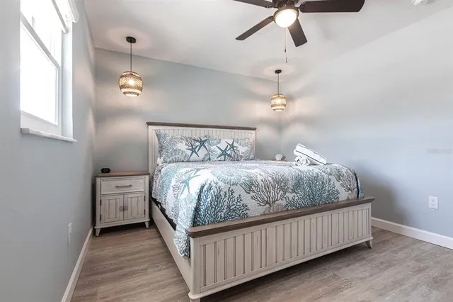 a bedroom with a bed and ceiling fan