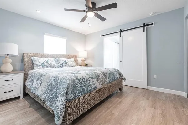 a bedroom with a bed and a night stand