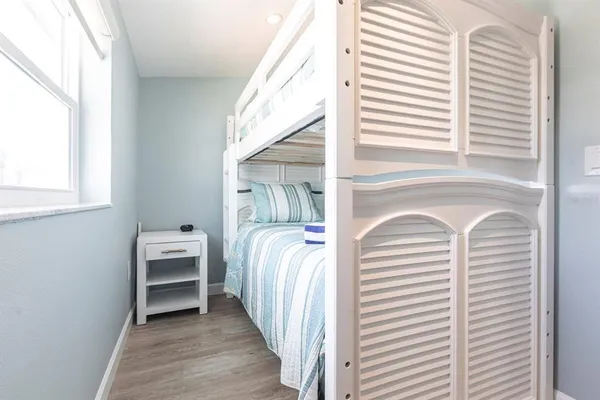 a view of a bedroom with a bed and a window
