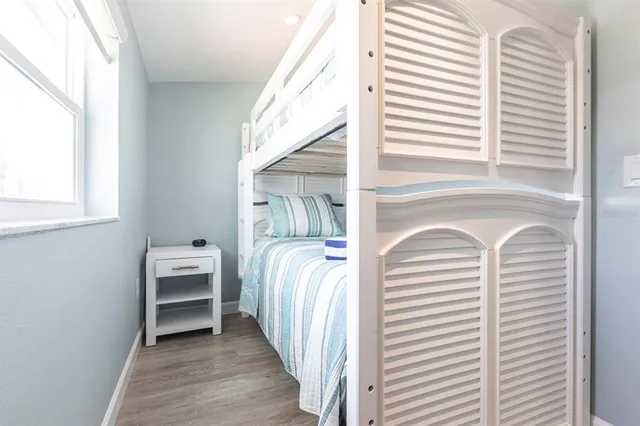 a view of a bedroom with a bed and a window