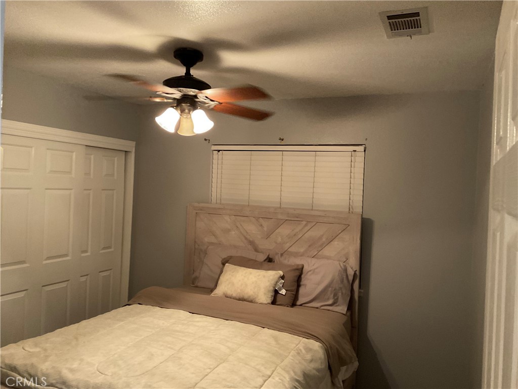3370 Hollowood Court Riverside, CA 92503 - Photo 12 of 14 a bedroom with a bed and a chandelier