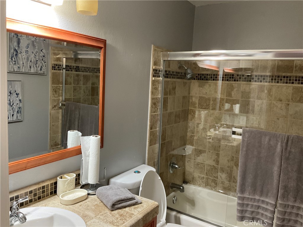 3370 Hollowood Court Riverside, CA 92503 - Photo 14 of 14 a bathroom with a granite countertop sink a toilet and shower