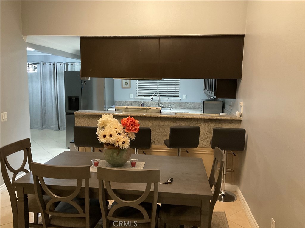 3370 Hollowood Court Riverside, CA 92503 - Photo 5 of 14 a dining table with chairs and stove