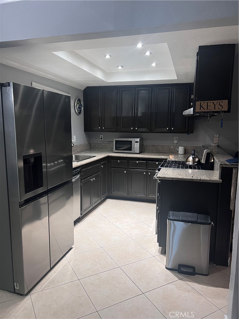 3370 Hollowood Court Riverside, CA 92503 - Photo 6 of 14 a kitchen with stainless steel appliances granite countertop a stove a sink and a refrigerator