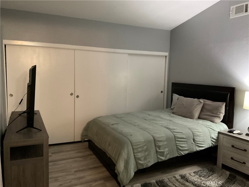 3370 Hollowood Court Riverside, CA 92503 - Photo 10 of 14 a bedroom with a bed and wooden floor
