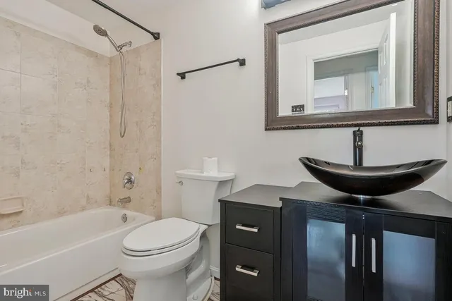 a bathroom with a toilet a sink and bathtub