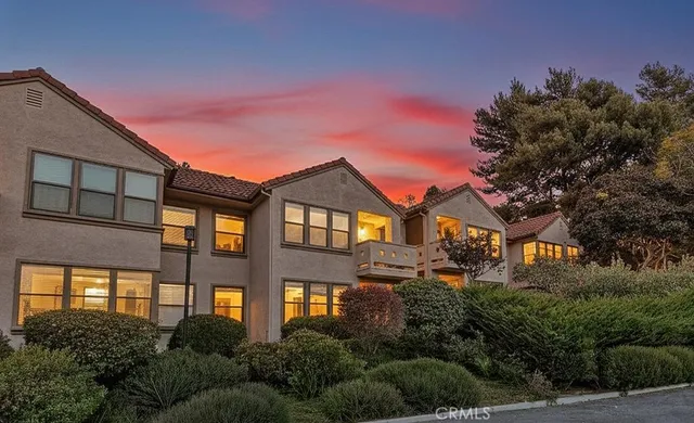a front view of a residential apartment building with a yard