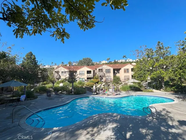a patio with a table and chairs under an umbrella