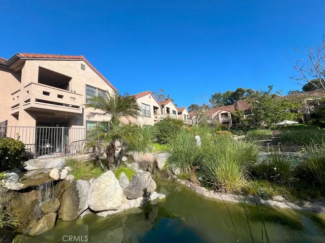 a view of a chair and tables in the patio next to a yard