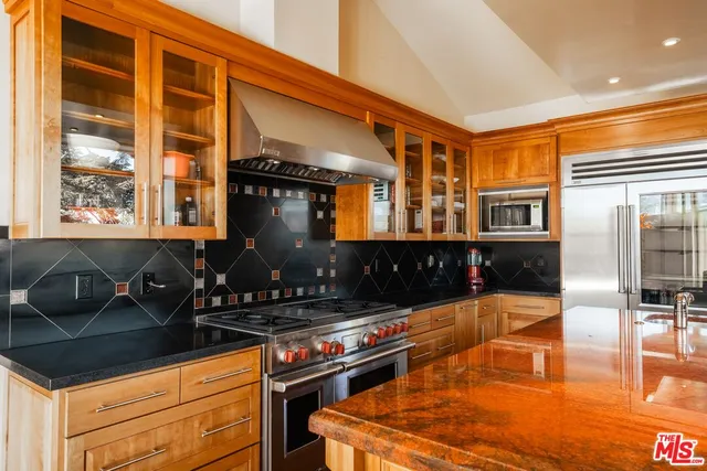 a kitchen with a sink and a stove top oven