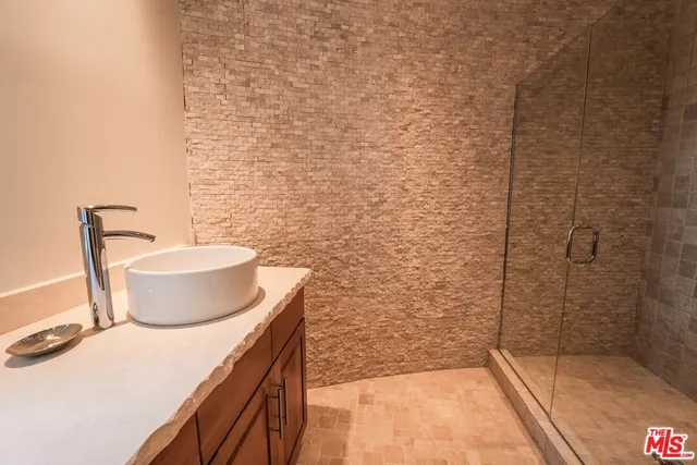 a roof deck with table and chairs and potted plants