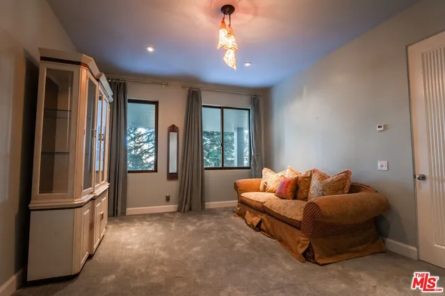 a front view of a house with a yard and mountain view