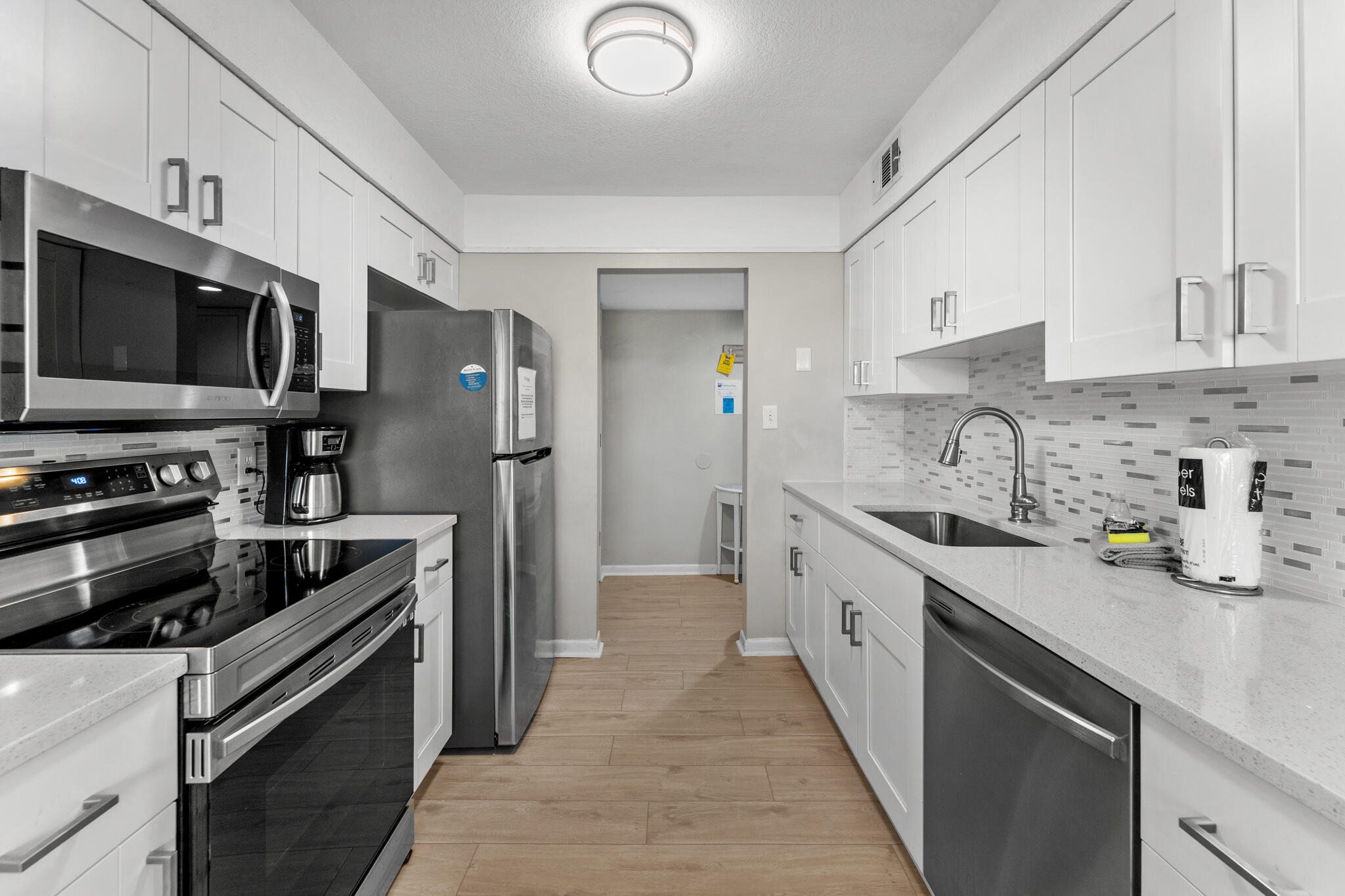 488 North Driftwood Bay, Unit 97F Miramar Beach, FL 32550 - Photo 12 of 31 a kitchen with stainless steel appliances a sink dishwasher a refrigerator and a stove