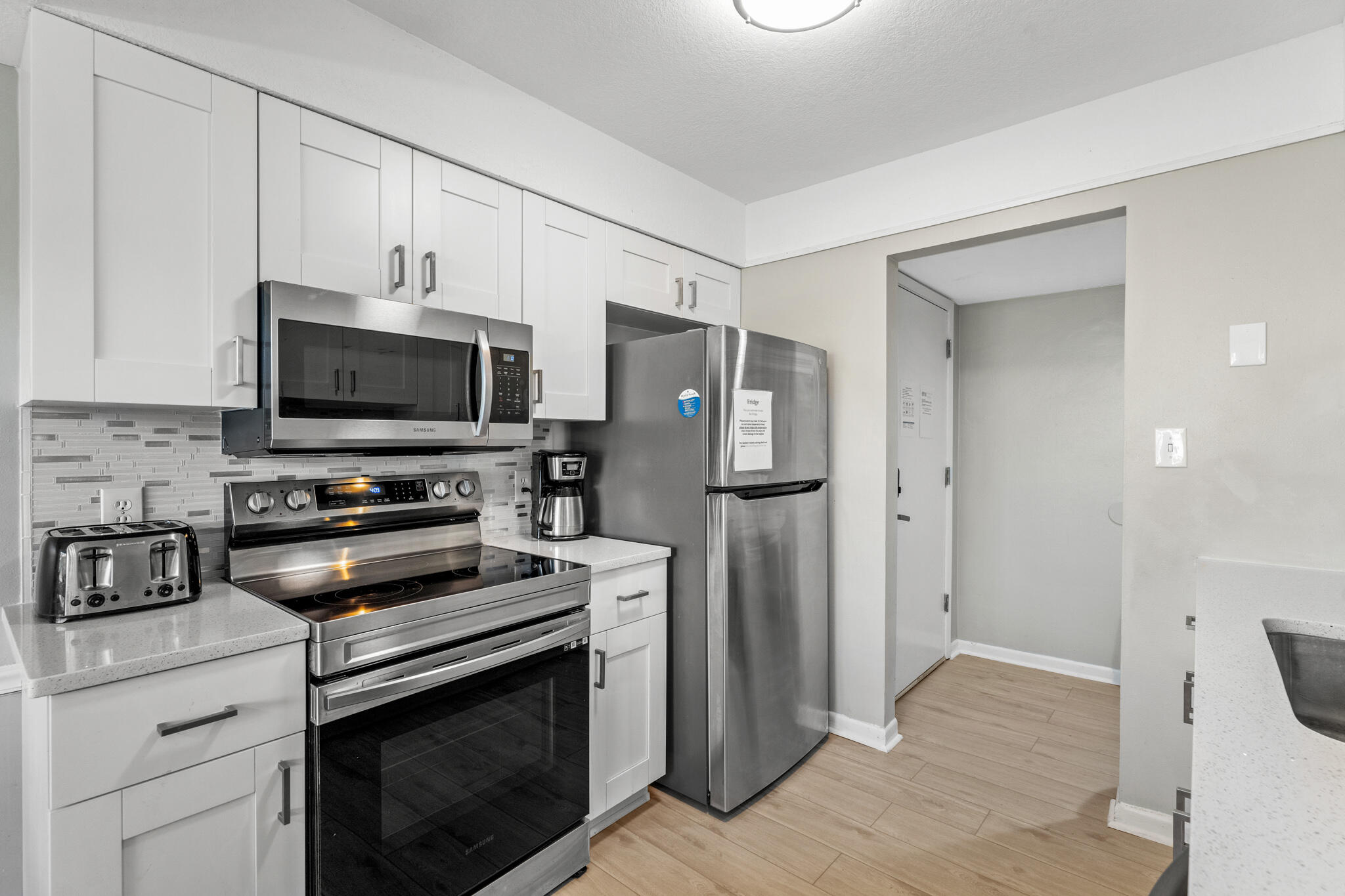 488 North Driftwood Bay, Unit 97F Miramar Beach, FL 32550 - Photo 13 of 31 a kitchen with stainless steel appliances a refrigerator stove and microwave