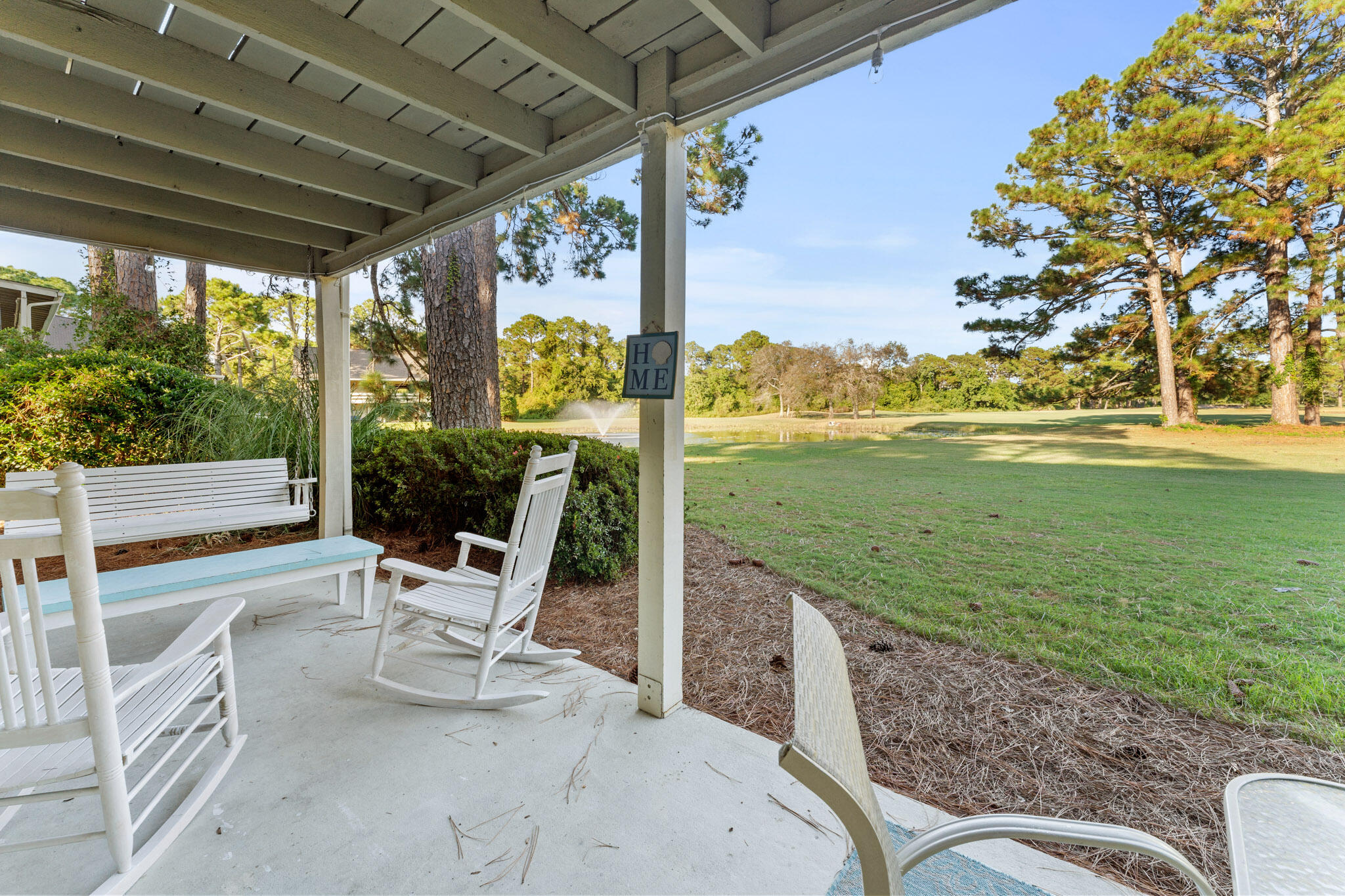 488 North Driftwood Bay, Unit 97F Miramar Beach, FL 32550 - Photo 22 of 31 a view of a chairs and table in patio with a yard