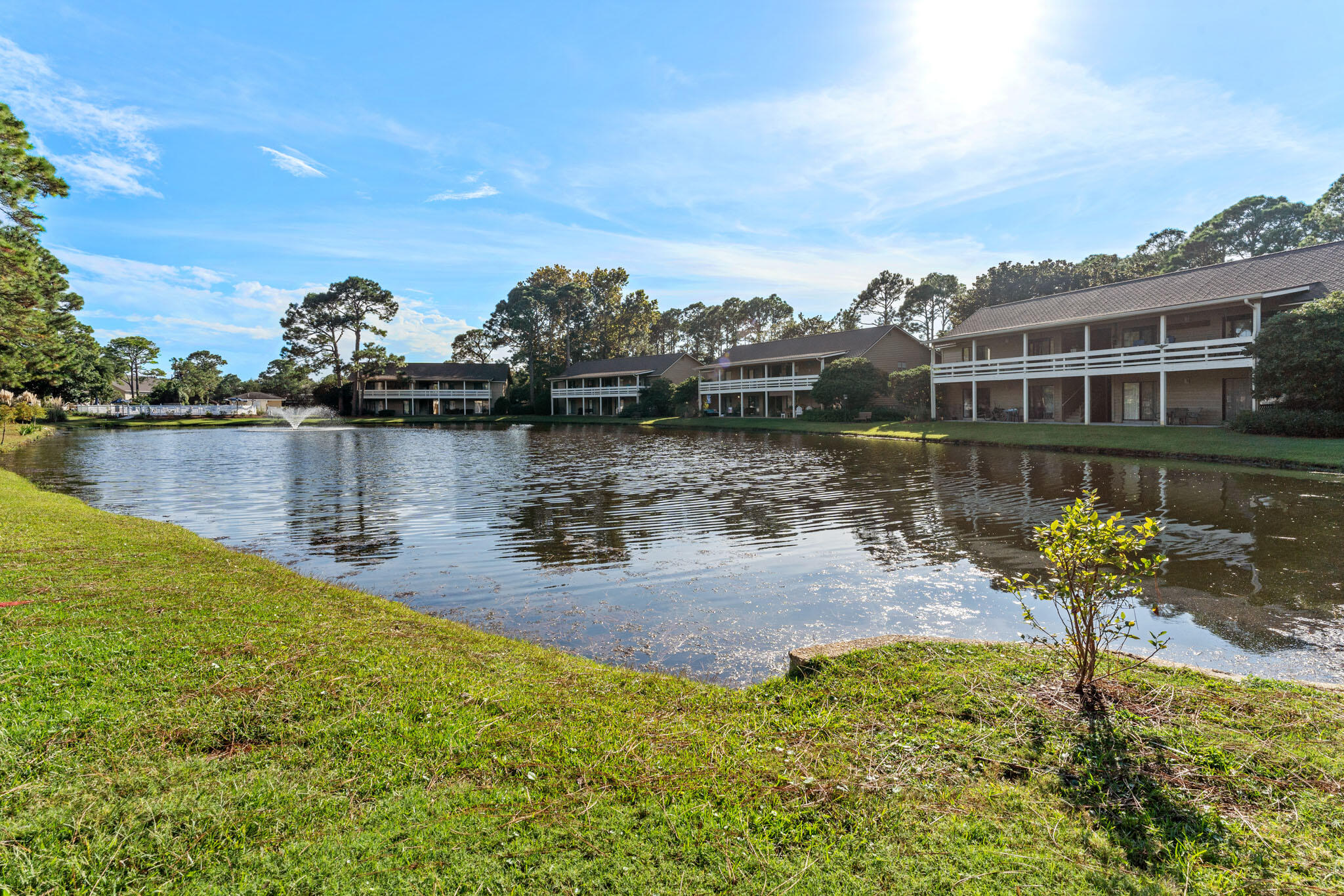 488 North Driftwood Bay, Unit 97F Miramar Beach, FL 32550 - Photo 24 of 31 a view of a lake with a house in the background