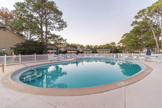 a view of swimming pool with outdoor seating and plants