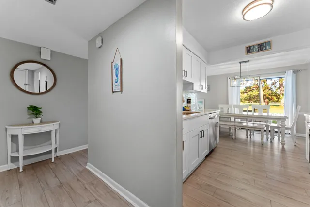 a kitchen with a sink cabinets and wooden floor