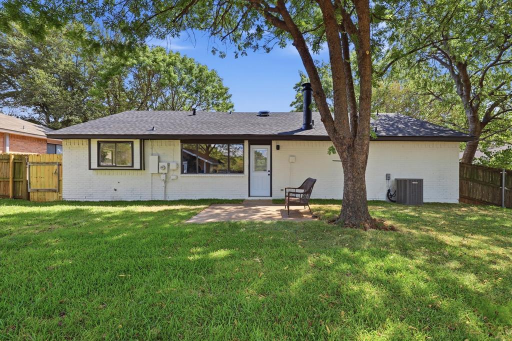 3405 Mill Ridge Street Bedford, TX 76021 - Photo 25 of 32 Expansive grassy backyard featuring a paved patio and mature trees