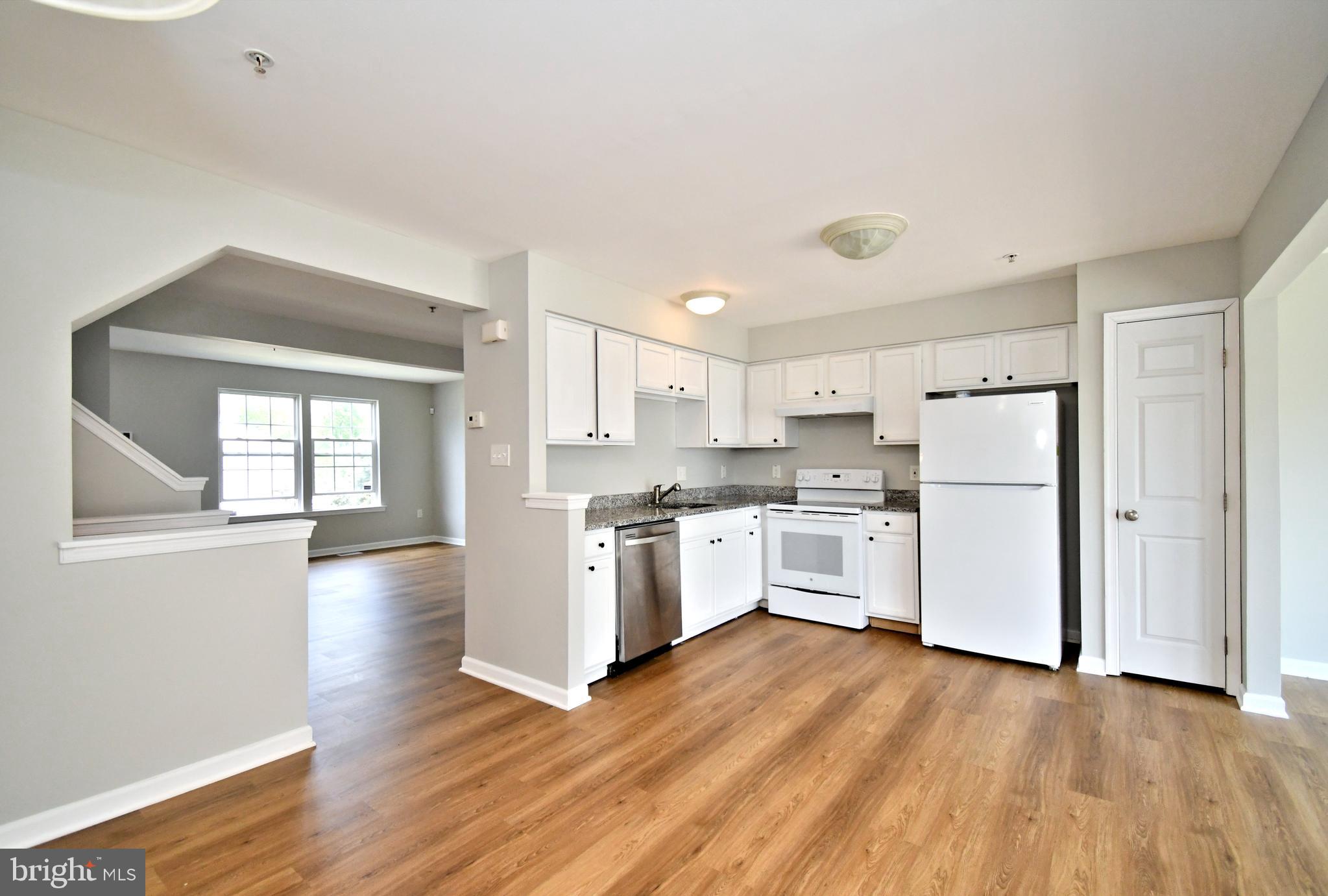 3306 Orchard View Road Reading, PA 19606 - Photo 3 of 16 a kitchen with a refrigerator and white cabinets