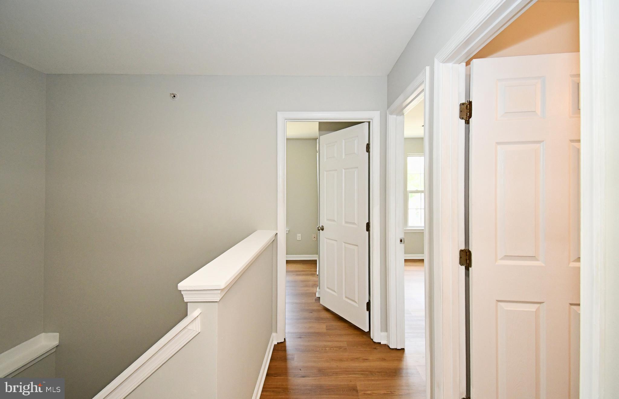 3306 Orchard View Road Reading, PA 19606 - Photo 7 of 16 a view of a hallway with wooden floor and staircase