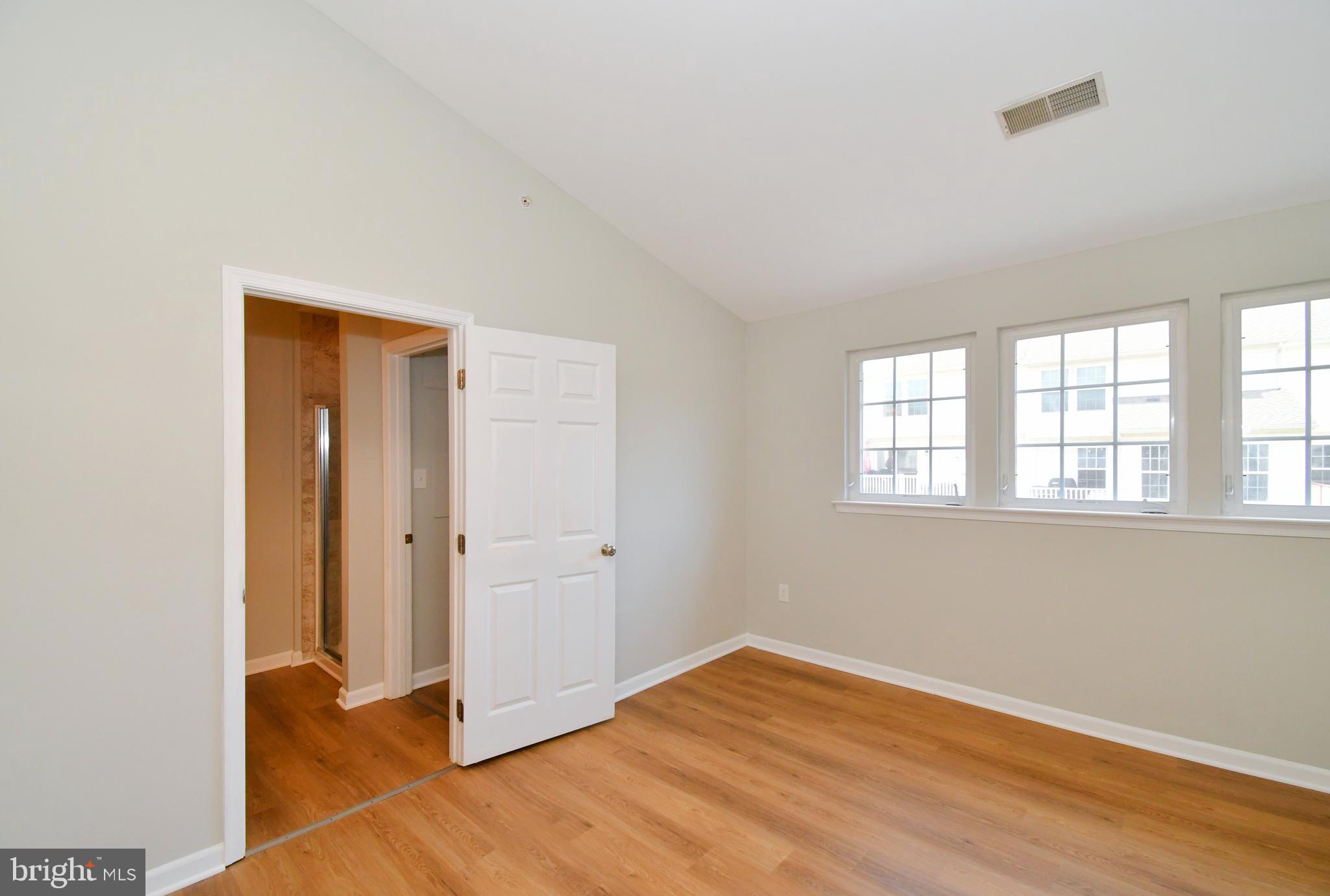 3306 Orchard View Road Reading, PA 19606 - Photo 8 of 16 an empty room with wooden floor and windows