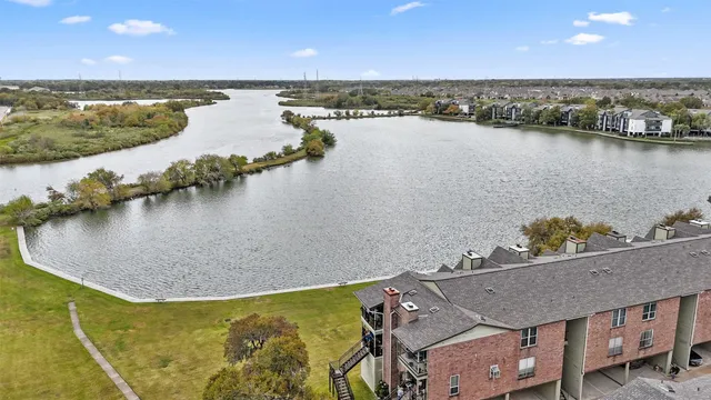 an aerial view of a house with a lake view