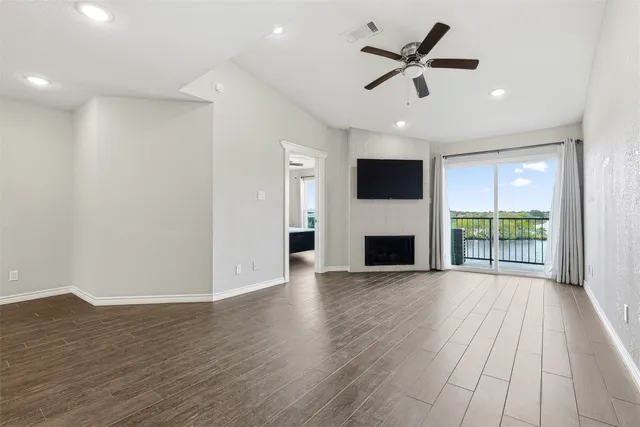 a view of a livingroom with kitchen and a flat screen tv