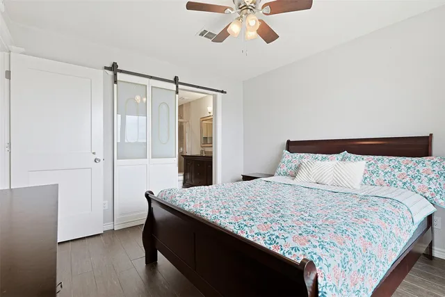 a bathroom with a granite countertop sink a toilet and a shower