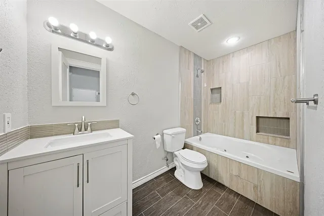 an empty room with fan and entrance