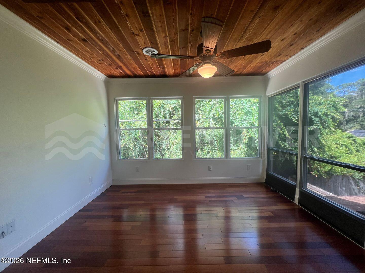 174 Eventide Drive Fleming Island, FL 32003 - Photo 13 of 60 a view of empty room with wooden floor and fan