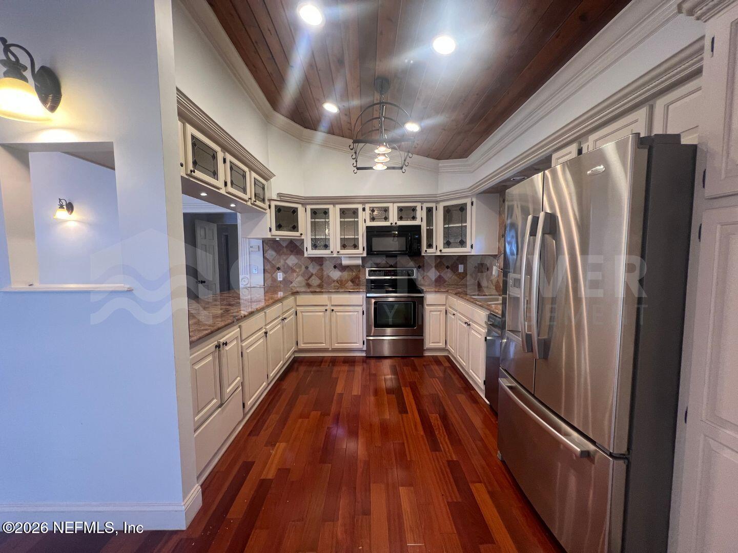 174 Eventide Drive Fleming Island, FL 32003 - Photo 23 of 60 a kitchen with stainless steel appliances a refrigerator a sink a stove top oven and cabinets