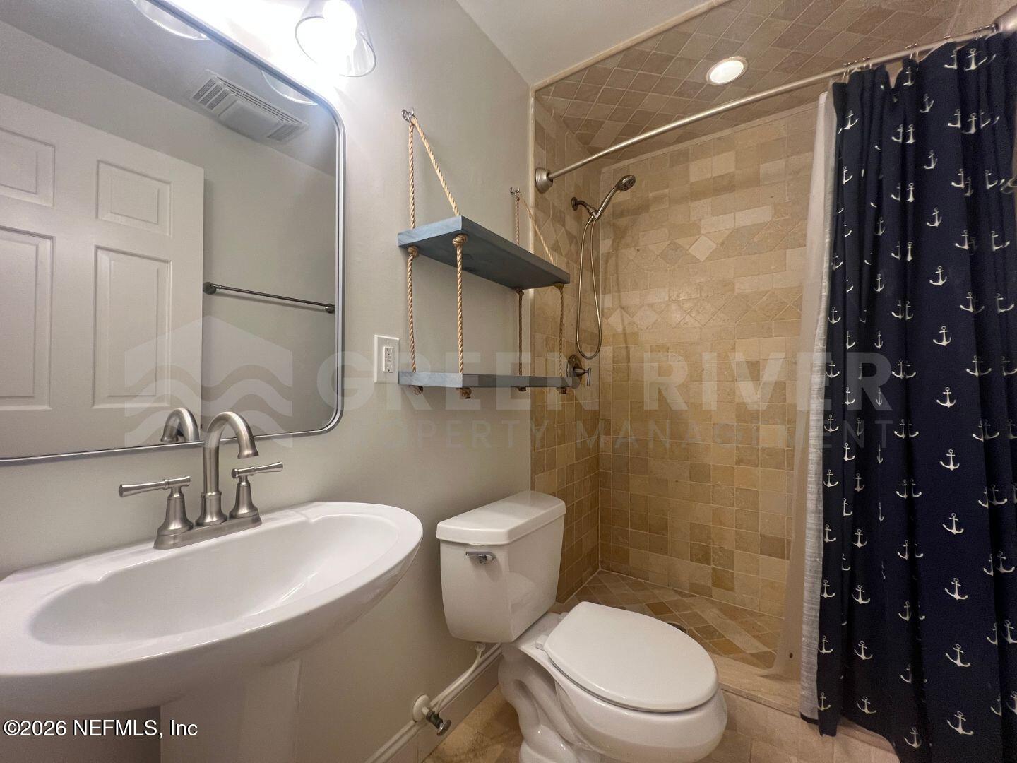 174 Eventide Drive Fleming Island, FL 32003 - Photo 27 of 60 a bathroom with a sink toilet and shower