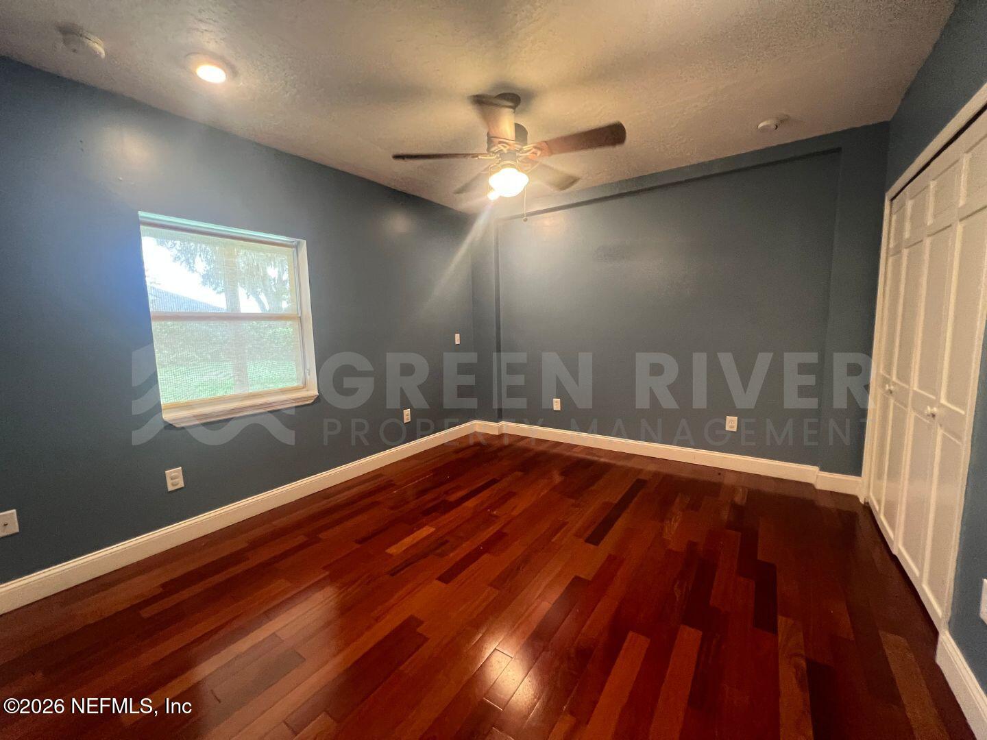 174 Eventide Drive Fleming Island, FL 32003 - Photo 34 of 60 wooden floor in an empty room with a window