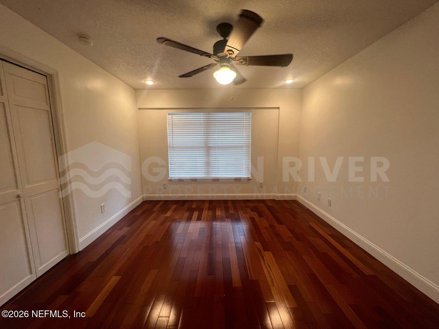 174 Eventide Drive Fleming Island, FL 32003 - Photo 36 of 60 a view of an empty room with wooden floor and a window