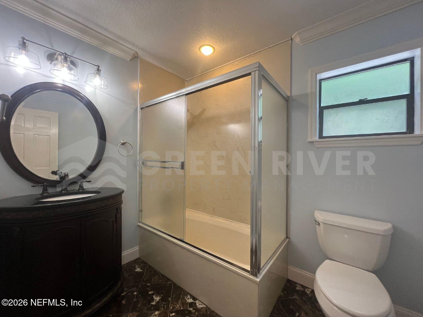 174 Eventide Drive Fleming Island, FL 32003 - Photo 38 of 60 a bathroom with a toilet a sink and a mirror