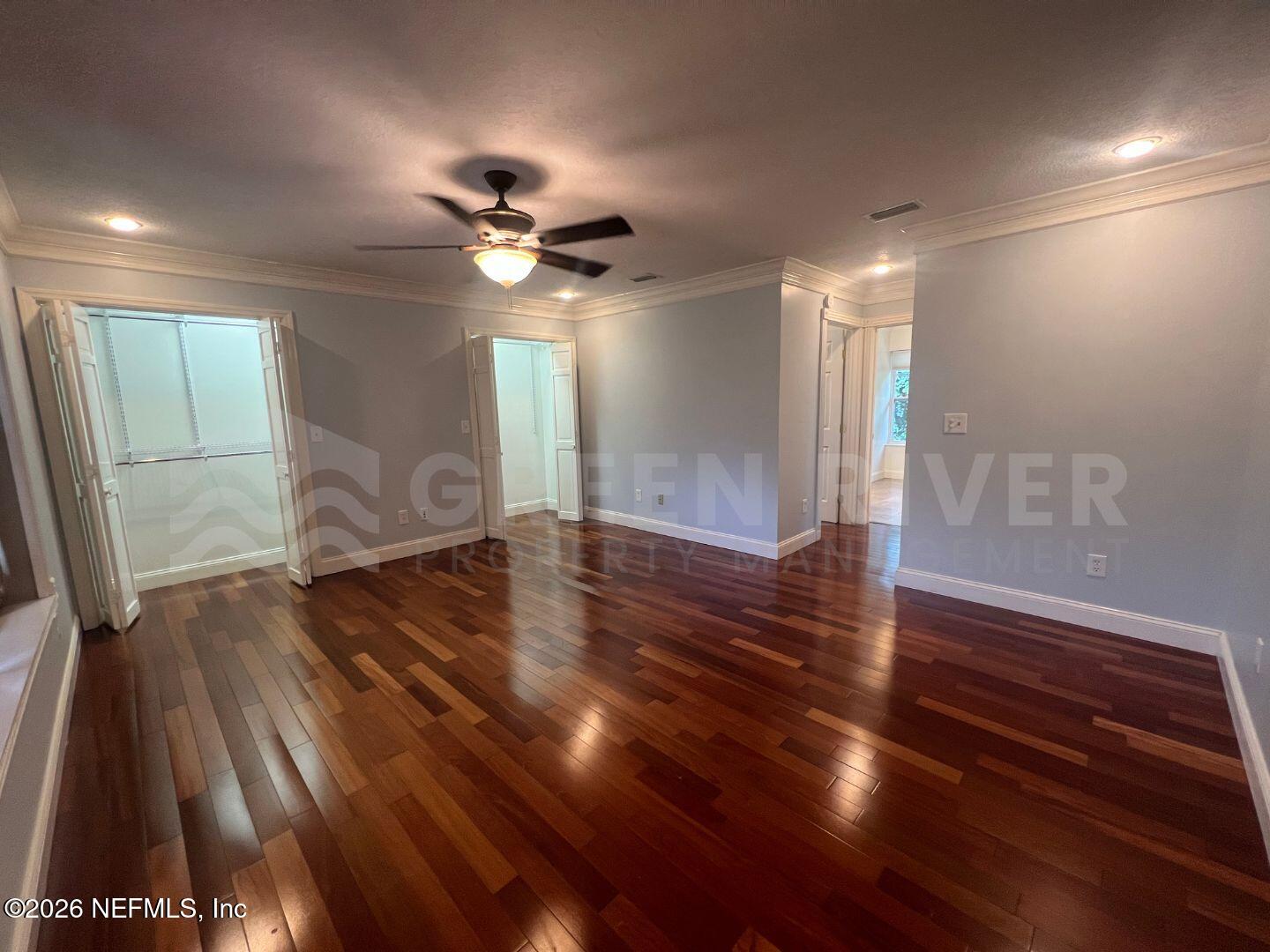 174 Eventide Drive Fleming Island, FL 32003 - Photo 46 of 60 a view of an empty room with wooden floor and a ceiling fan