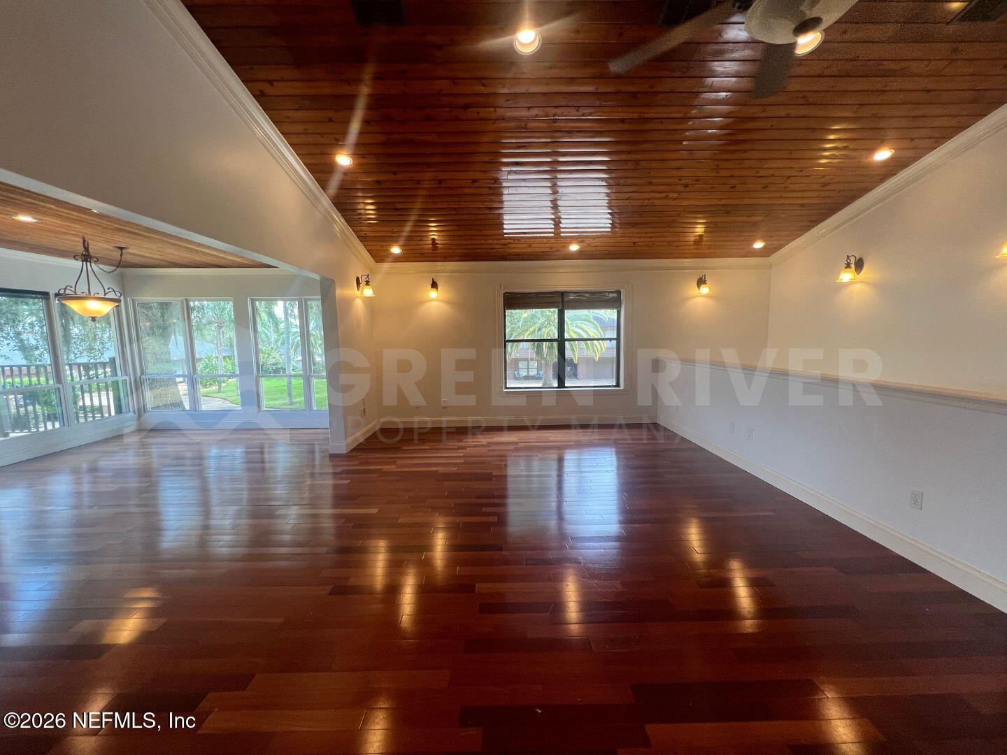 174 Eventide Drive Fleming Island, FL 32003 - Photo 7 of 60 a view of empty room with wooden floor