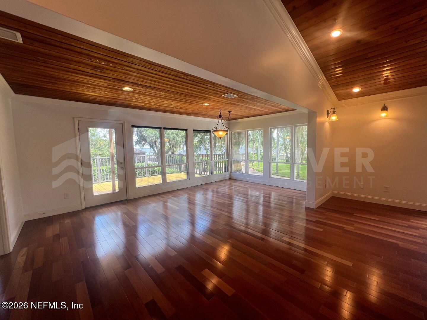 174 Eventide Drive Fleming Island, FL 32003 - Photo 9 of 60 a view of empty room with wooden floor and fan