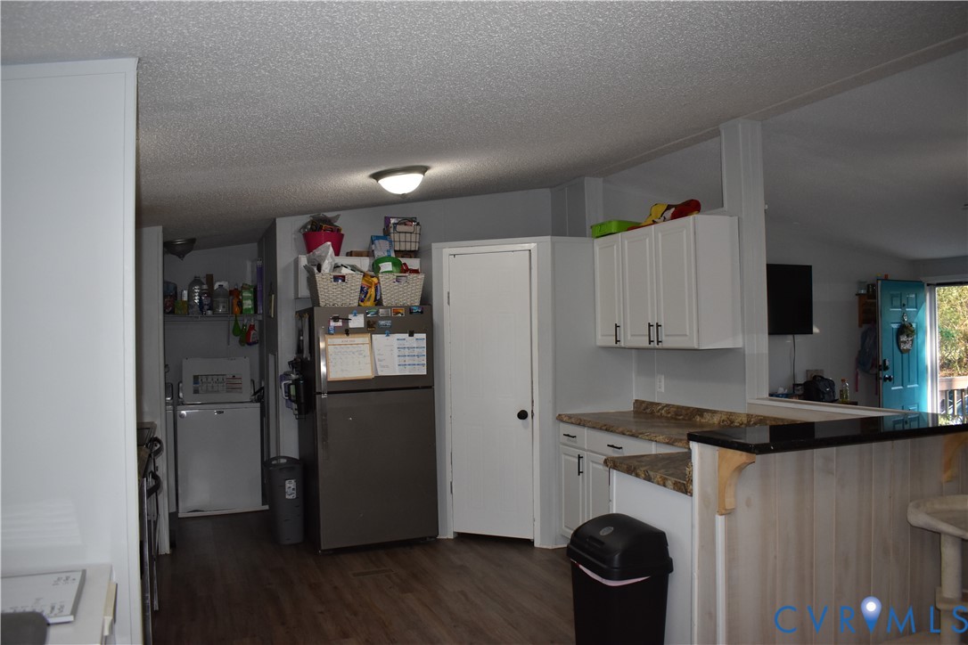 26049 Guy Place Road Courtland, VA 23837 - Photo 13 of 24 Kitchen area featuring wood-finish flooring, white