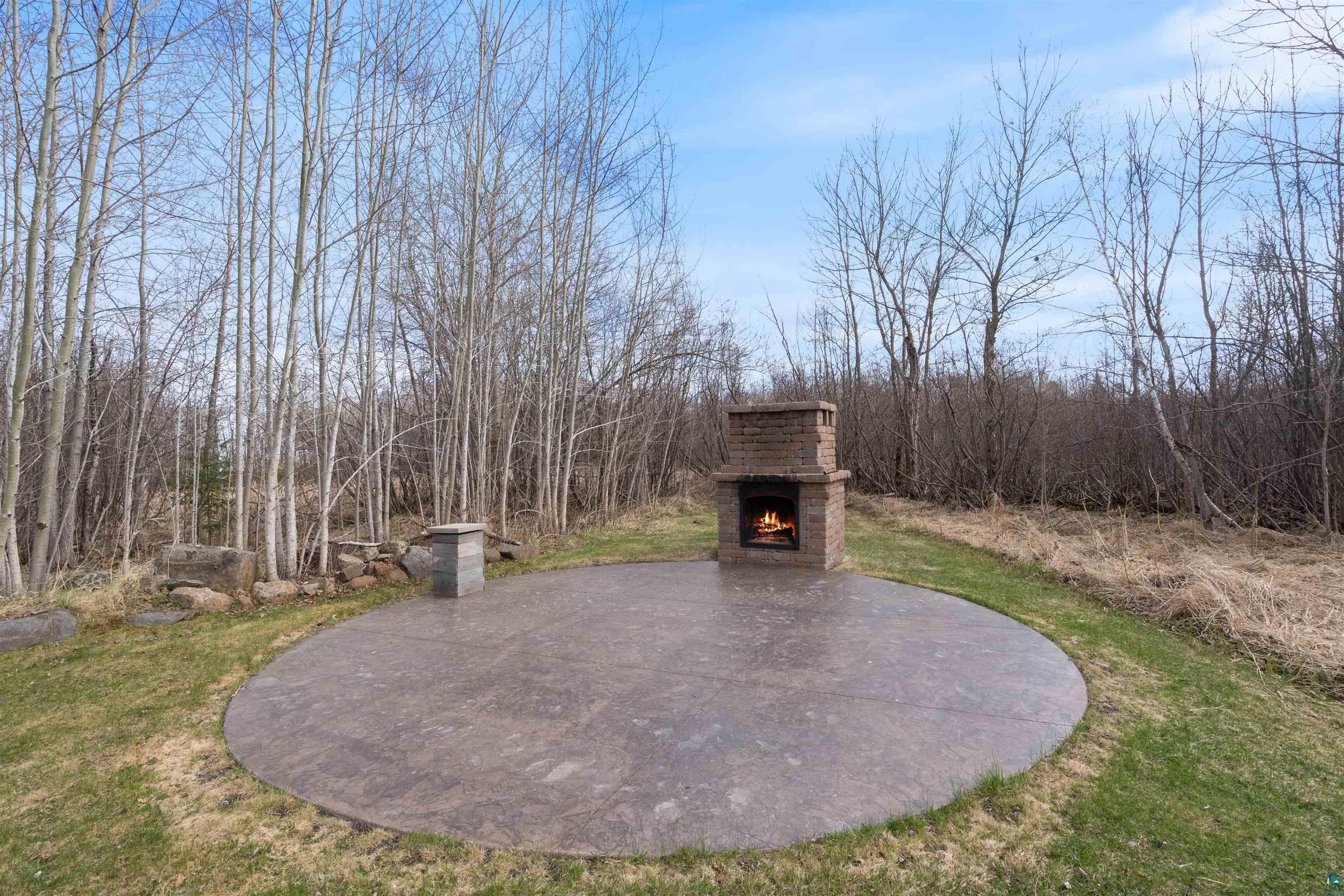 4354 Ugstad Road Hermantown, MN 55811 - Photo 41 of 57 New Stained Concrete Patio and Custom Outdoor Fireplace