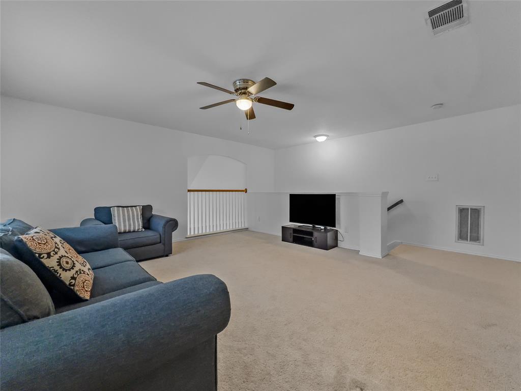 3008 Devlin Ridge Drive Plano, TX 75025 - Photo 16 of 24 Expansive carpeted area featuring a ceiling fan with integrated lighting, a recessed light fixture, and white wall finishes