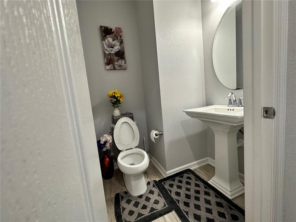 250 Rustic Loop Sanford, FL 32771 - Photo 11 of 33 a bathroom with a sink toilet and a mirror