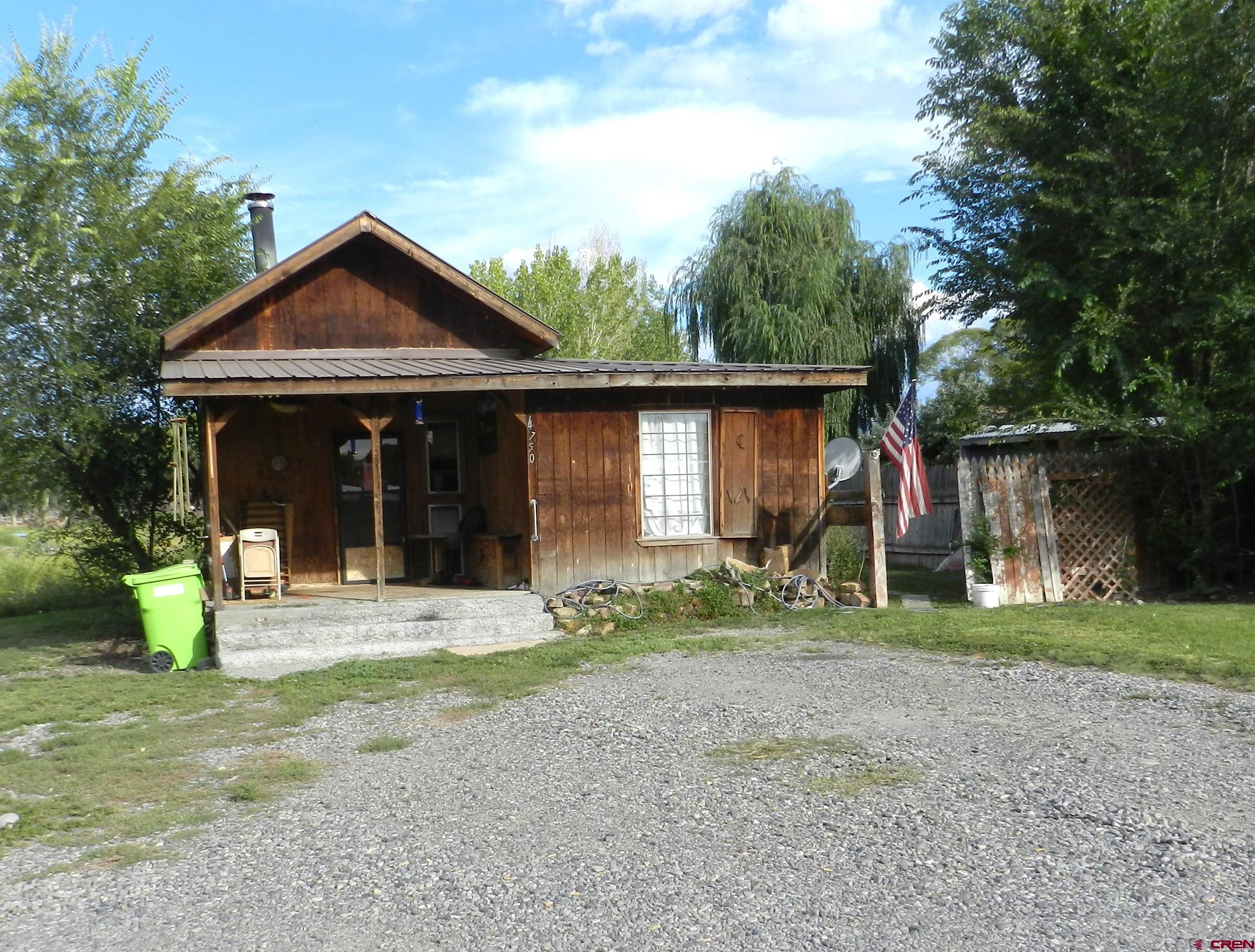 755 Spring Creek Road Montrose, CO 81403 - Photo 27 of 33 a front view of a house with garden