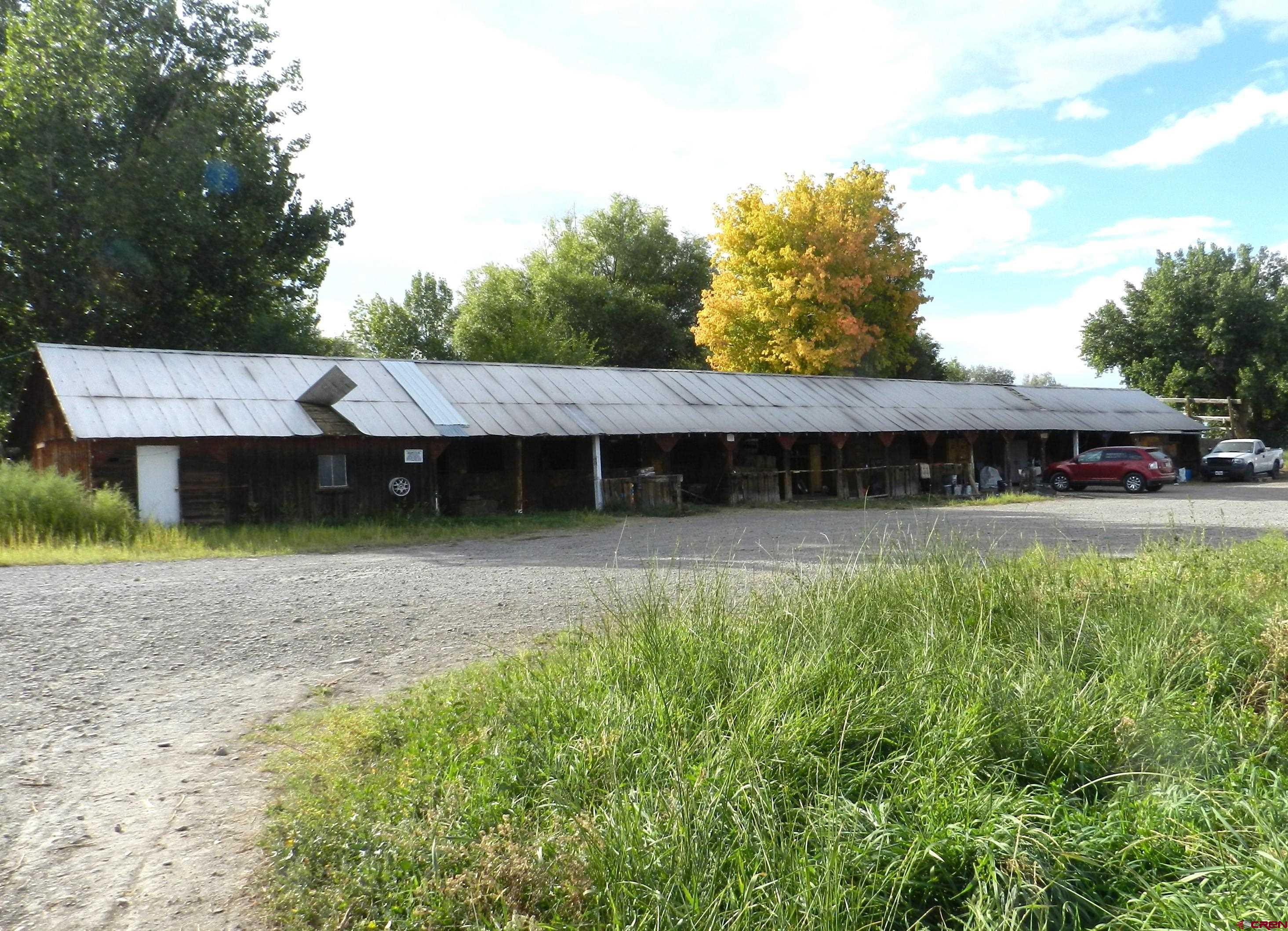 755 Spring Creek Road Montrose, CO 81403 - Photo 28 of 33 a view of a house with a yard