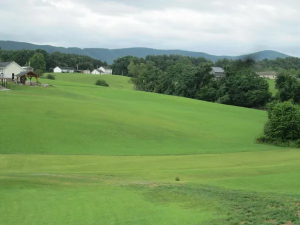 a view of a field with a building in the background