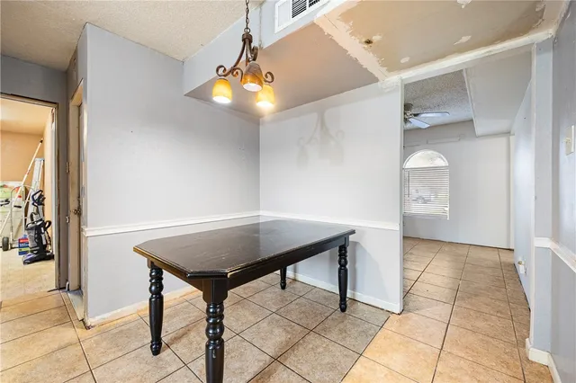a view of a room with a table and chairs