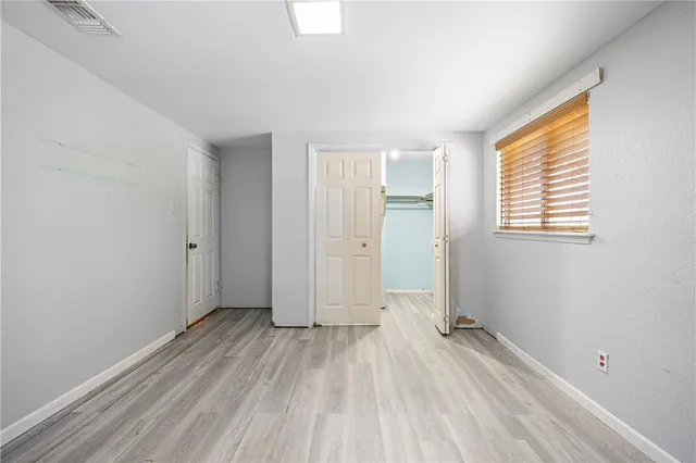 a view of a room with wooden floor and windows